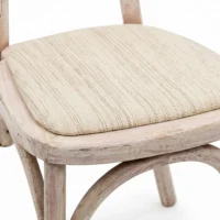 Silla Marian de madera de pino con respaldo en bejuco sintético y asiento tapizado. Ideal para interiores.